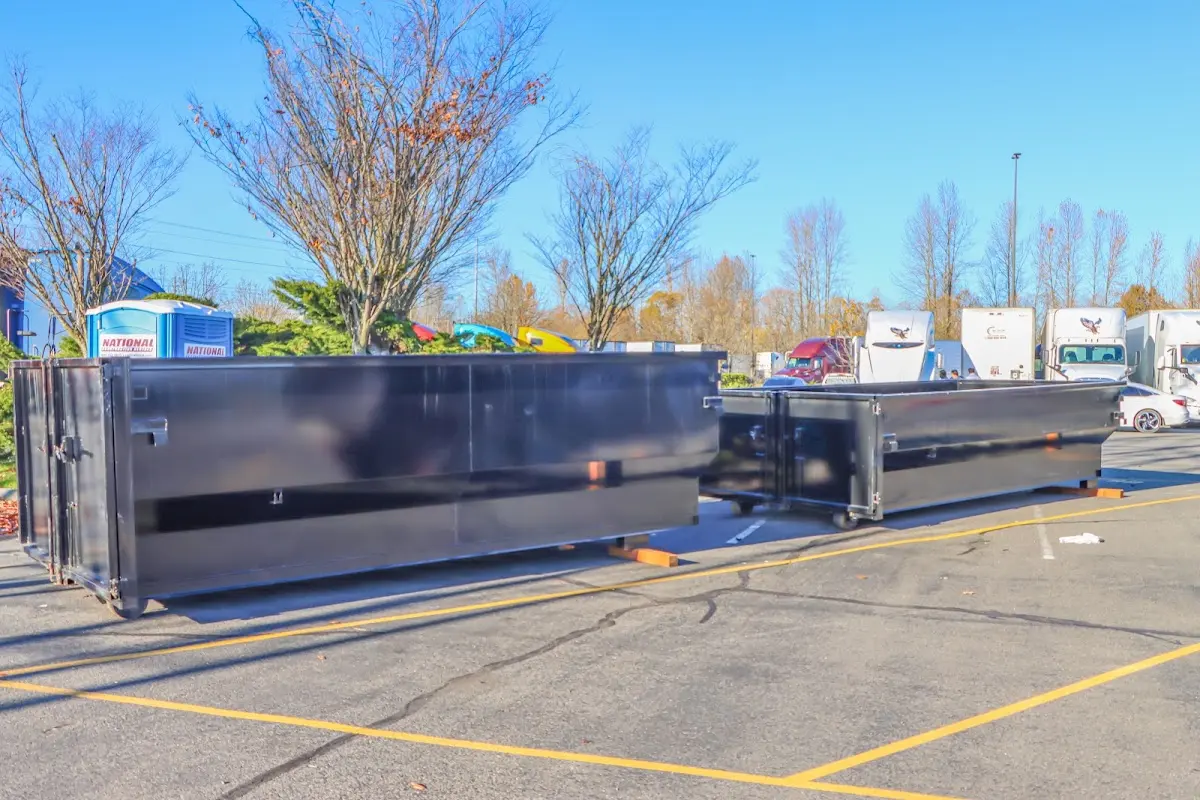 Professional dumpster rental service with roll-off container on residential driveway in Slippery Rock